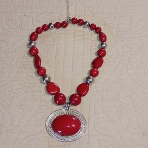 Red and silver costume necklace with pendant